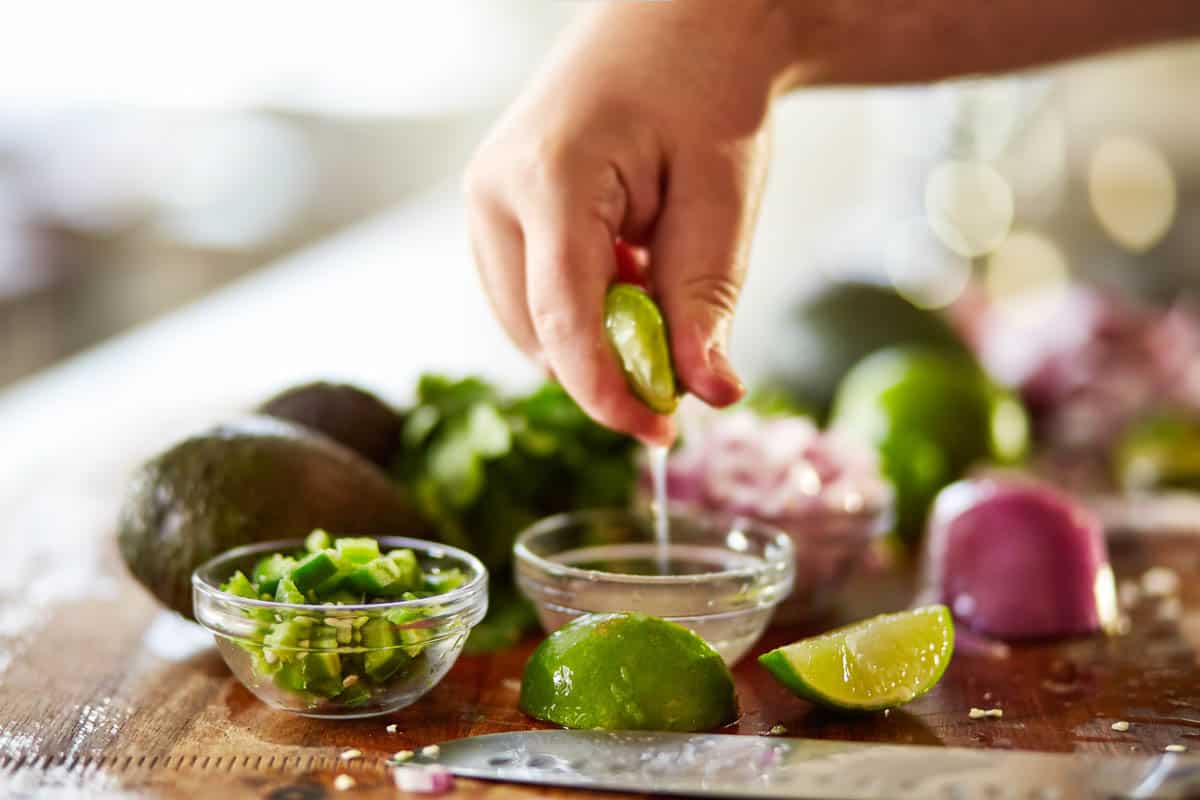 squeezing lime juice for guacamole recipe.