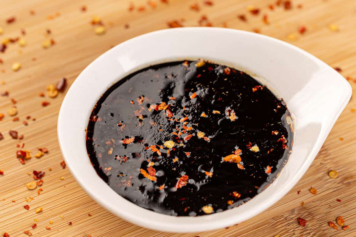 Bowl of teriyaki sauce, traditional Japanese sauce on bamboo board