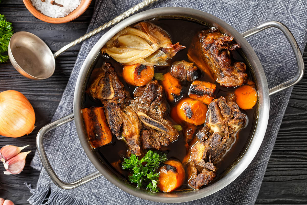 beef broth of beef meat on bones slow cooked with charred vegetables: carrot, onion, garlic.