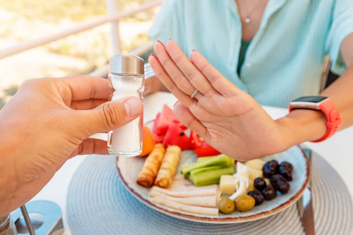 Woman in a restaurant refuses the offered salt