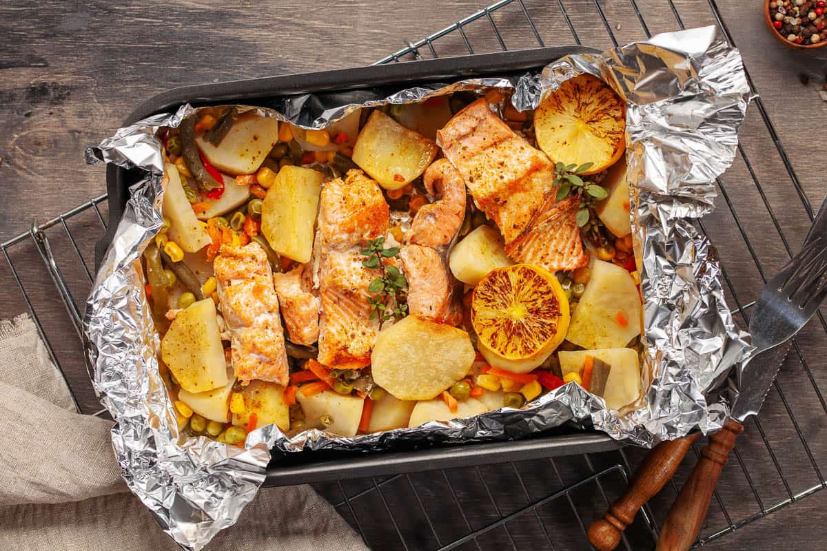 Foil pack dinners. Salmon with vegetables baked in foil.