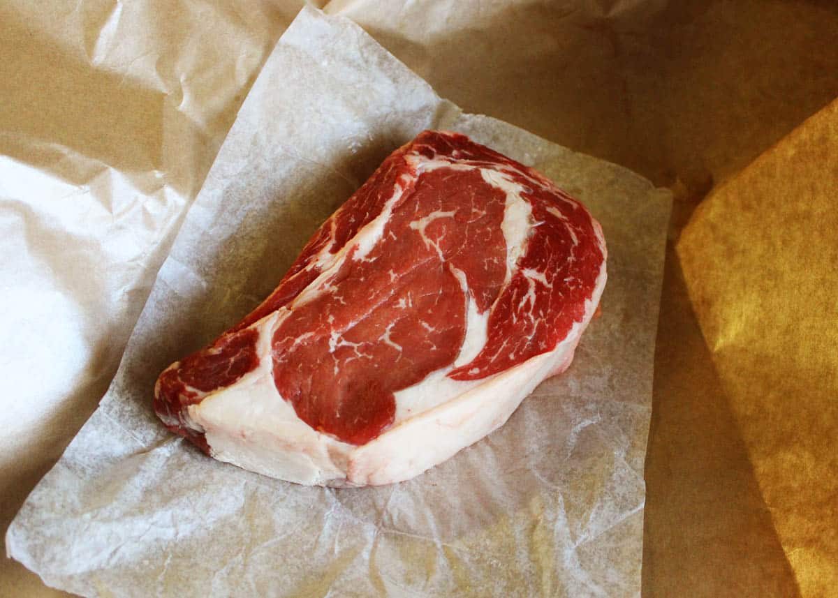 Raw Ribeye Steak on Butcher Paper.