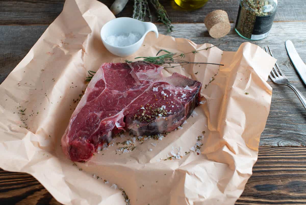 Raw steak on butcher paper.