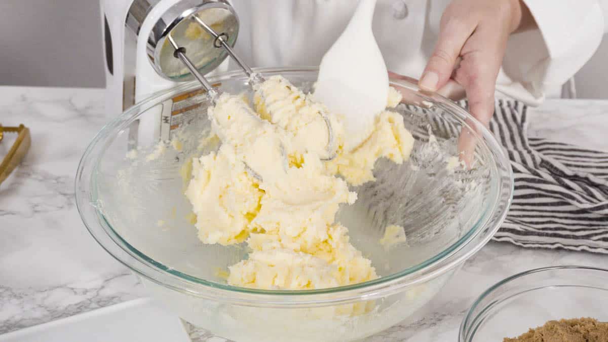 Step by step. Mixing ingredients in a glass bowl to make chocolate chip cookies.