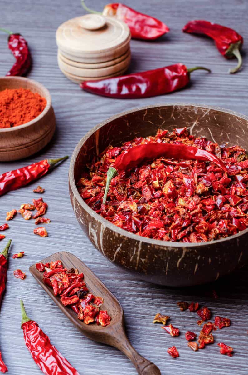 Red dried pepper on a dark wooden background.