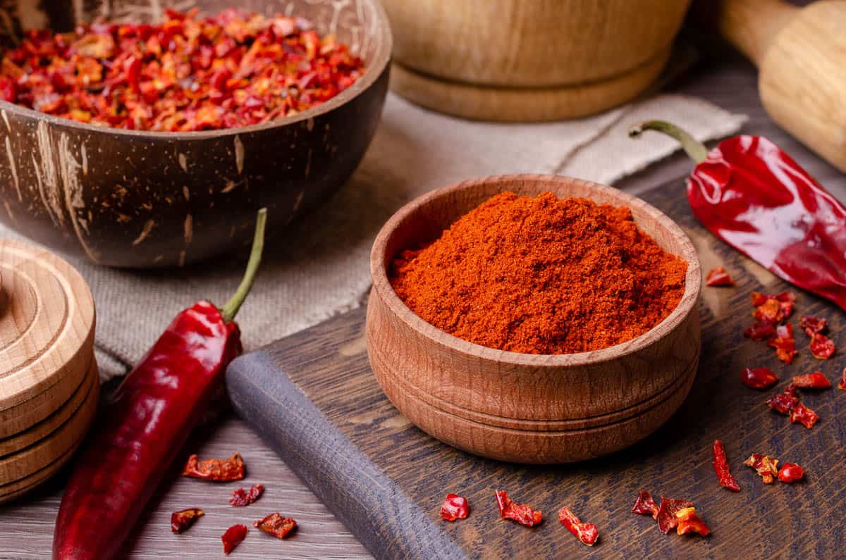 Red dried pepper on a dark wooden background.