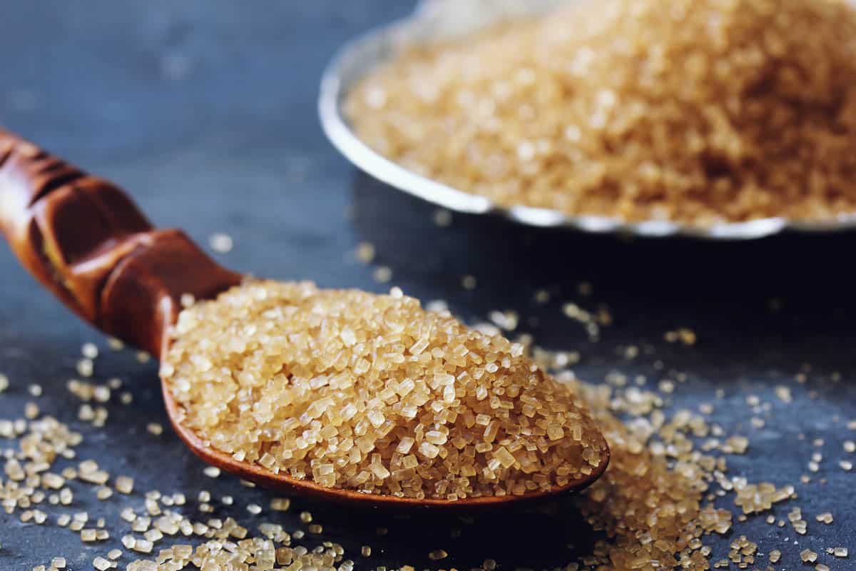 Raw sugar close up on spoon.