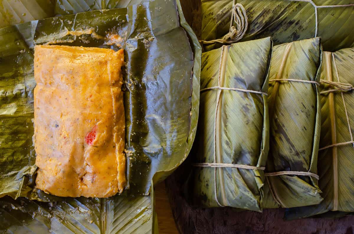 tamale with masa inside leaves.