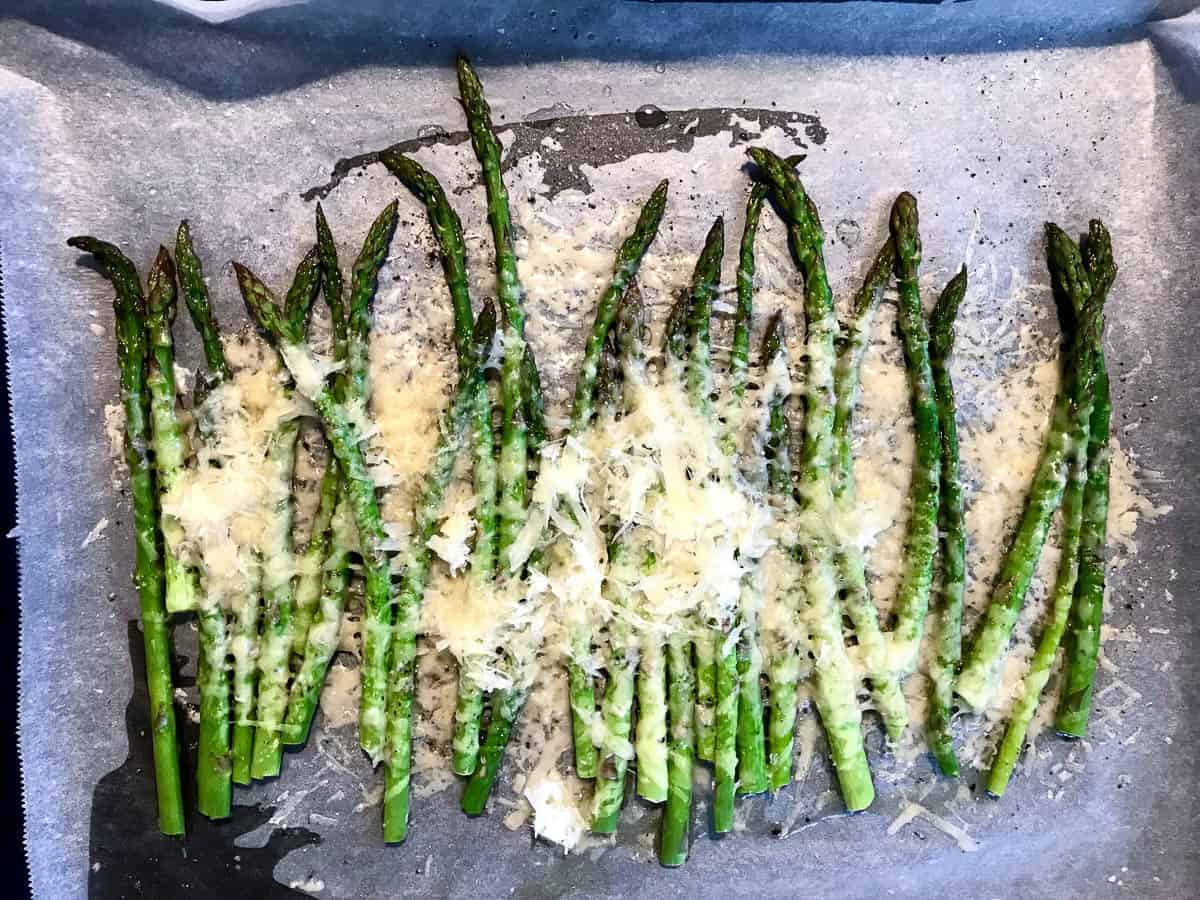 Baked Asparagus with Parmesan Cheese on Baking Paper.