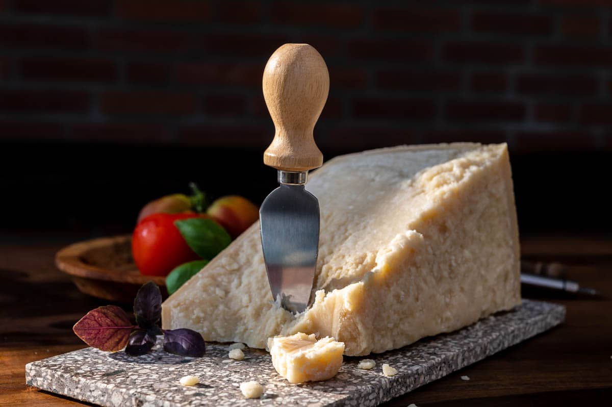 parmigiano reggiano on cutting board.