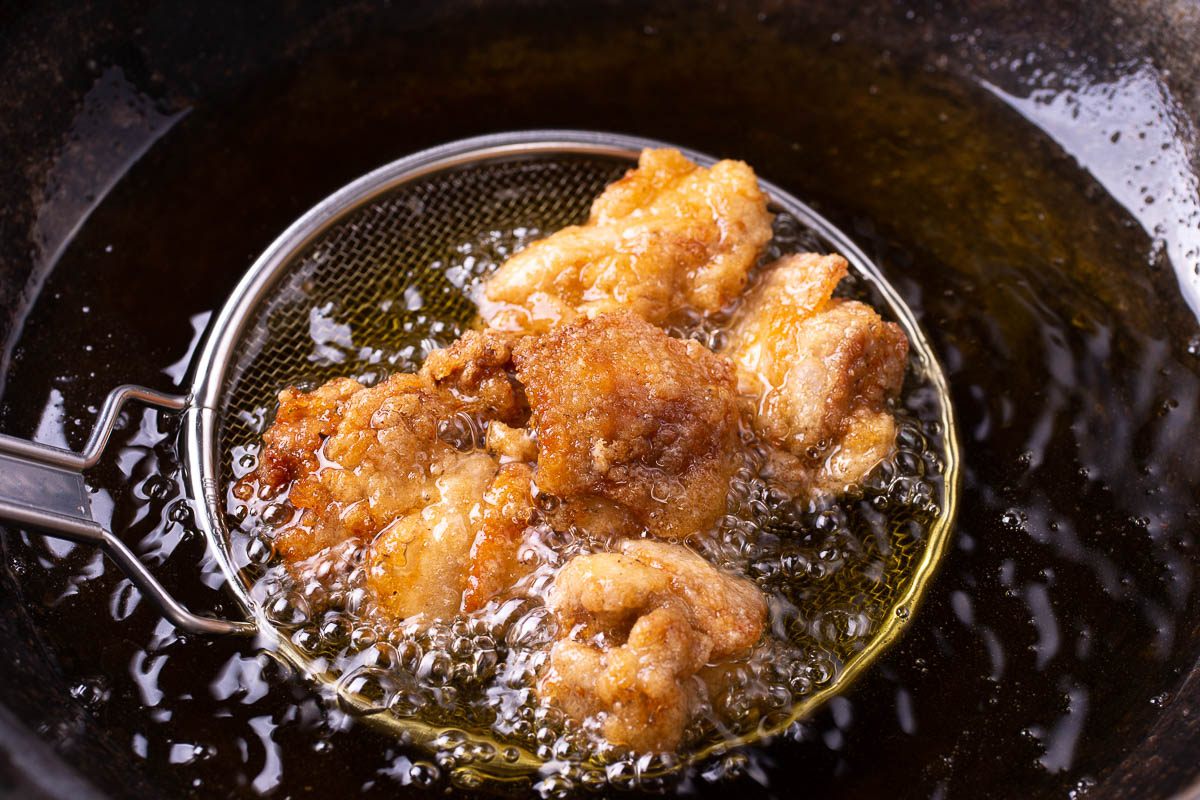 deep Fried chicken in basket over oil.