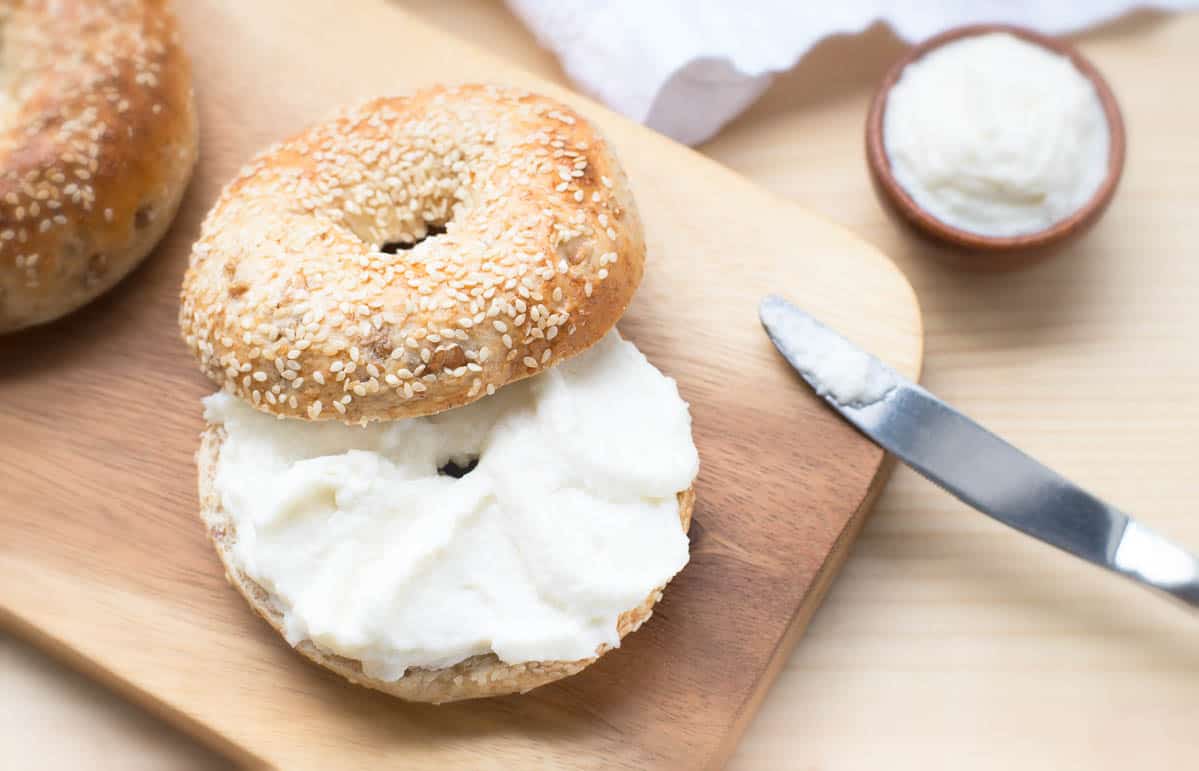 Bagel sesame with spread cream cheese.