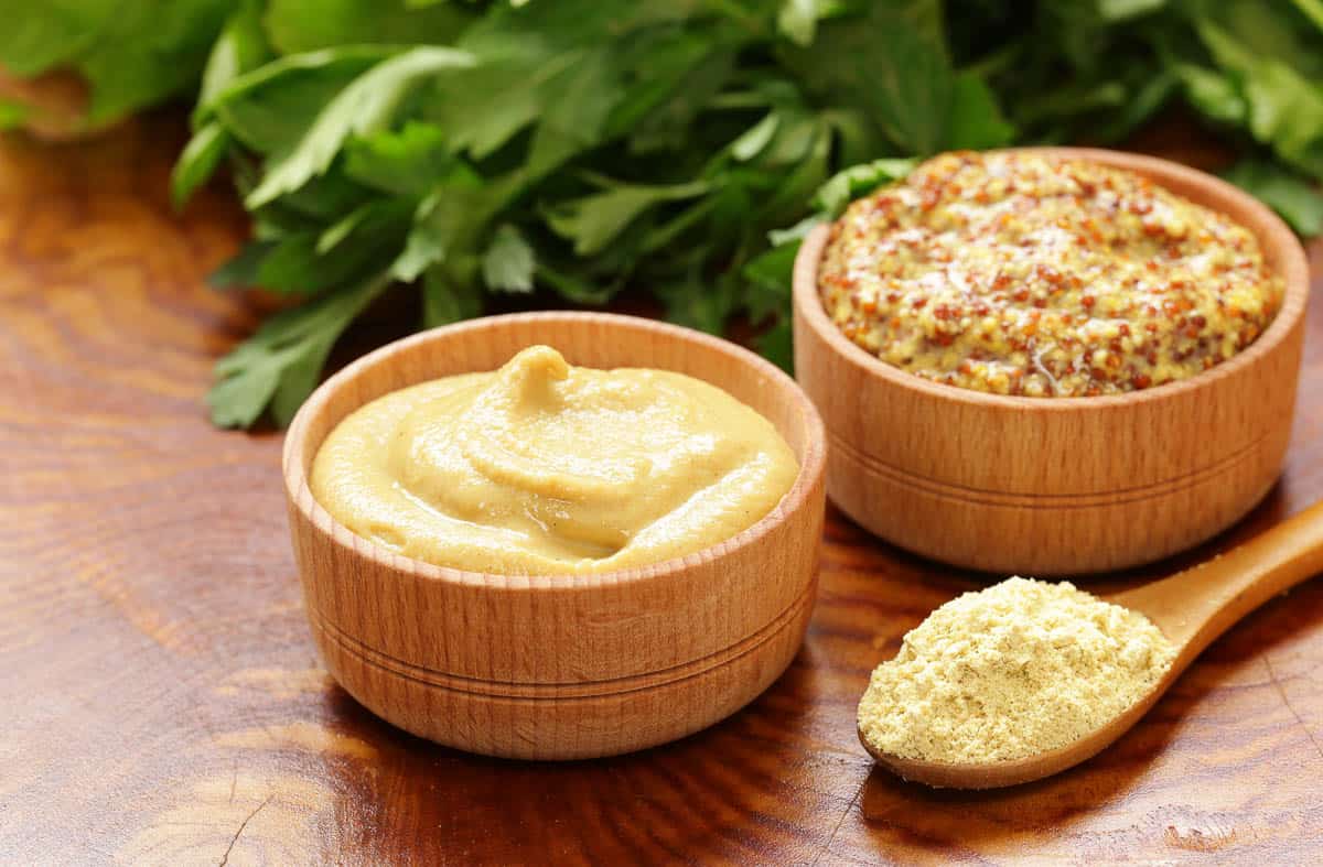 Natural mustard, seasoning and sauce on a wooden table