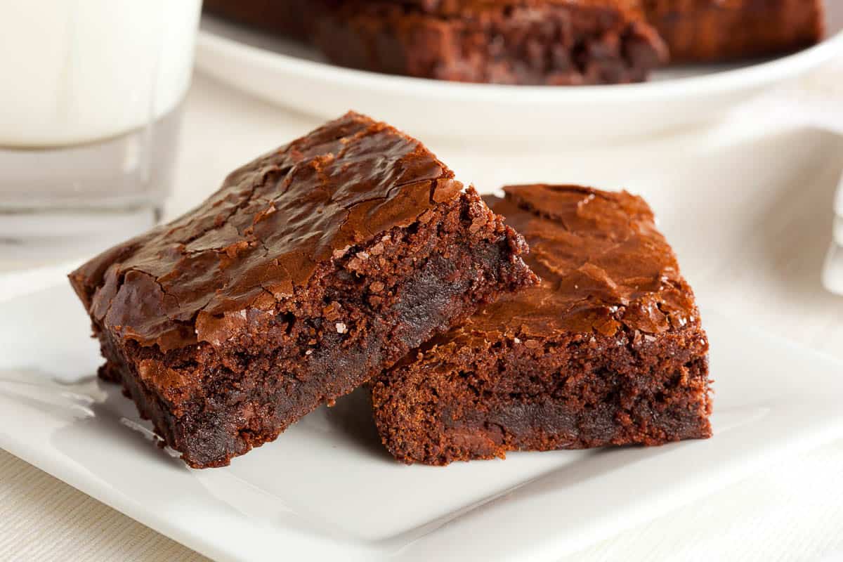 Fresh Homemade Chocolate Brownie against a white background.