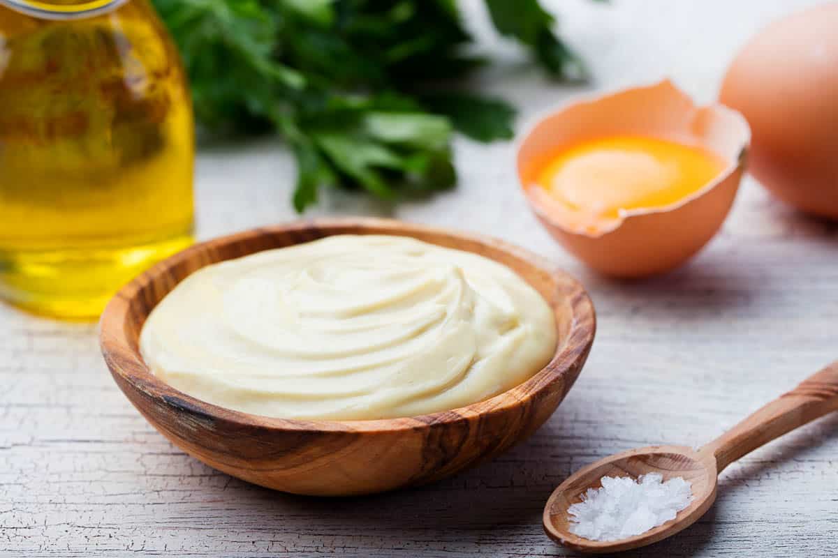 Homemade mayonnaise, mayo in a wooden bowl.