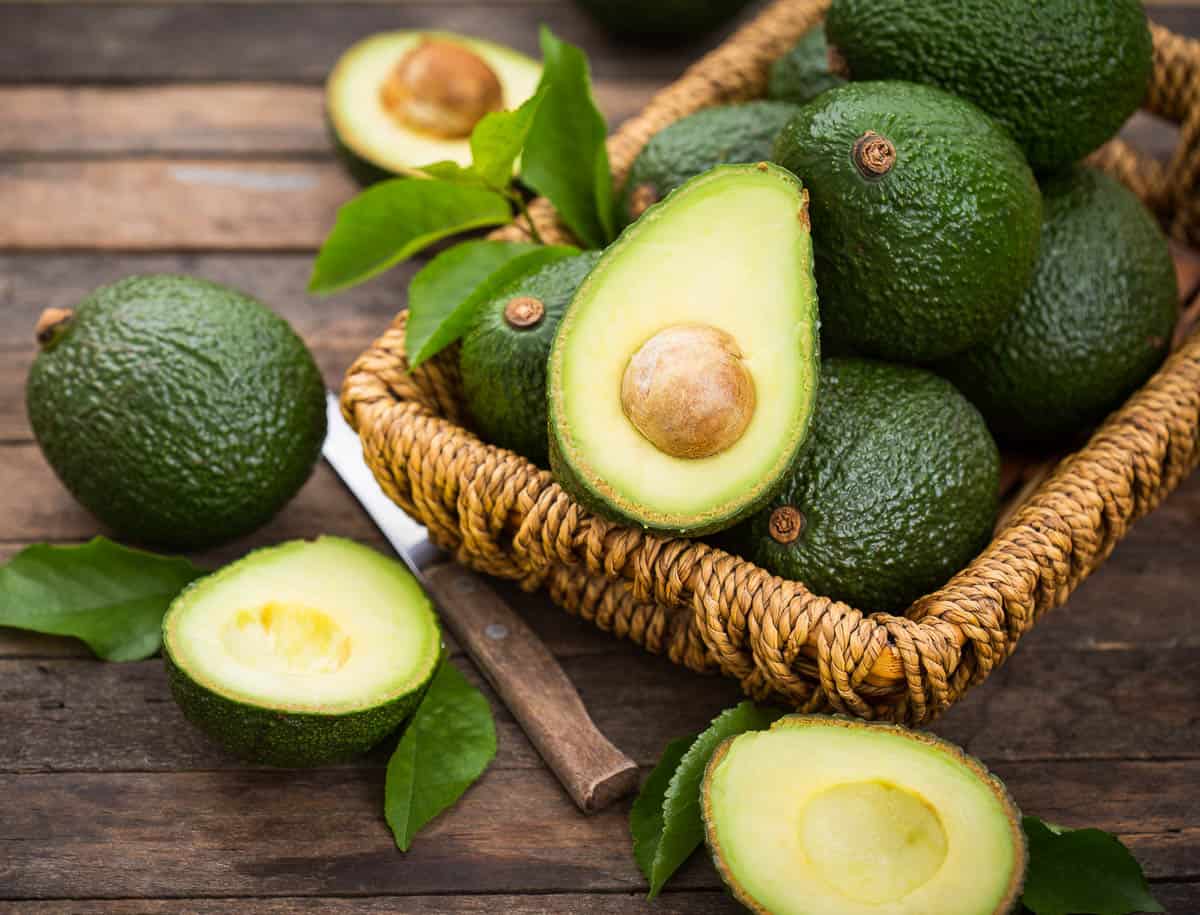 Fresh organic avocado on the wooden table.