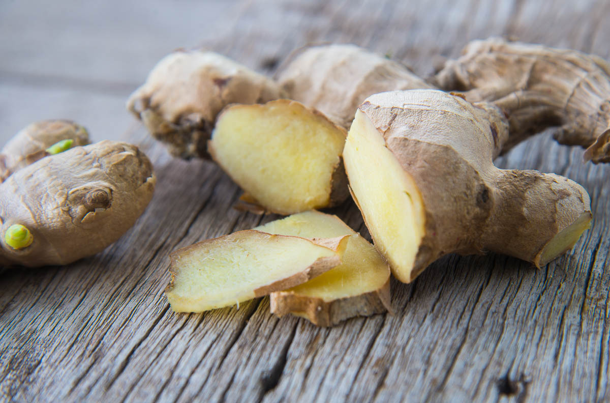 cut Ginger on wood texture.