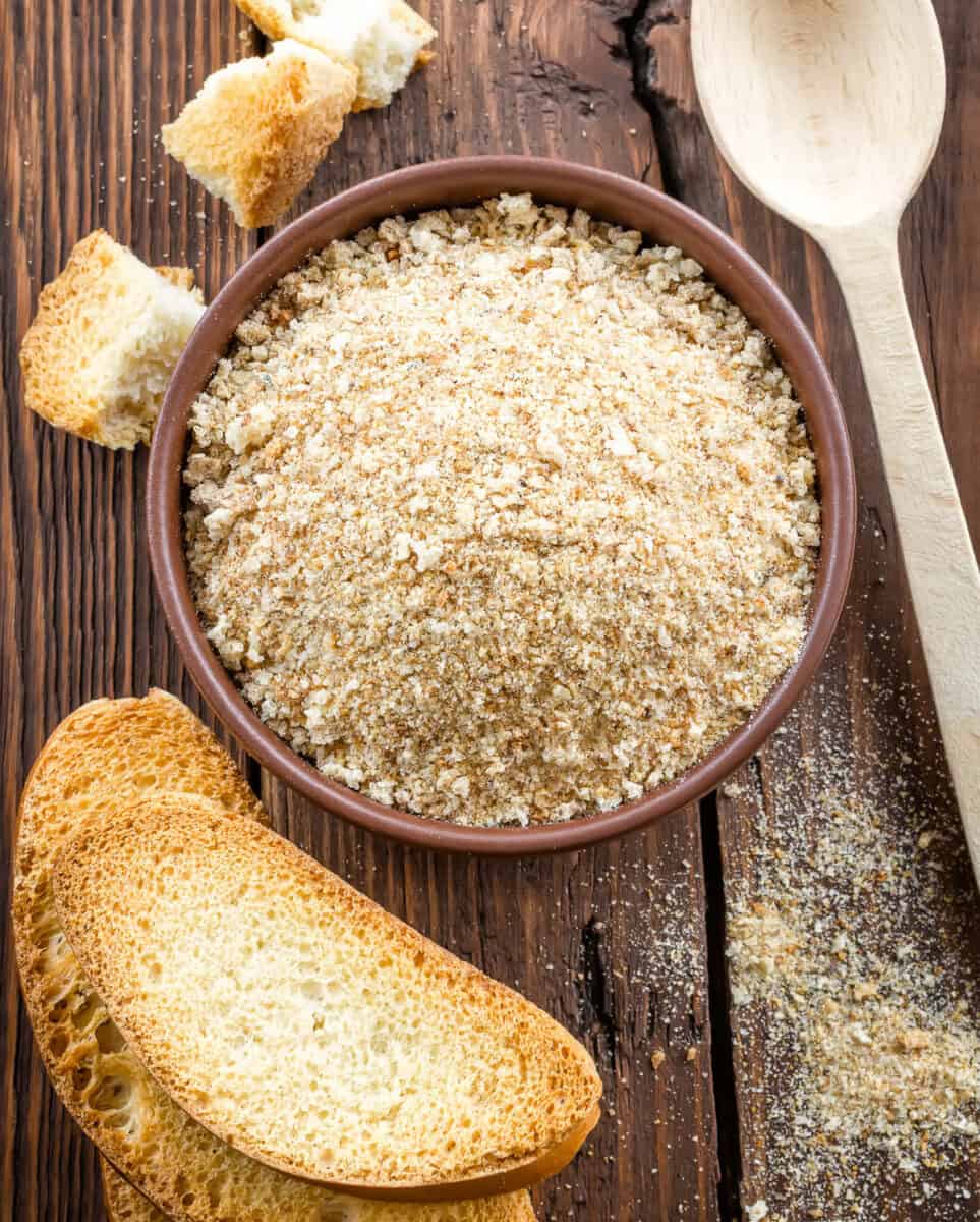 Breadcrumbs in round dish with toast on side.