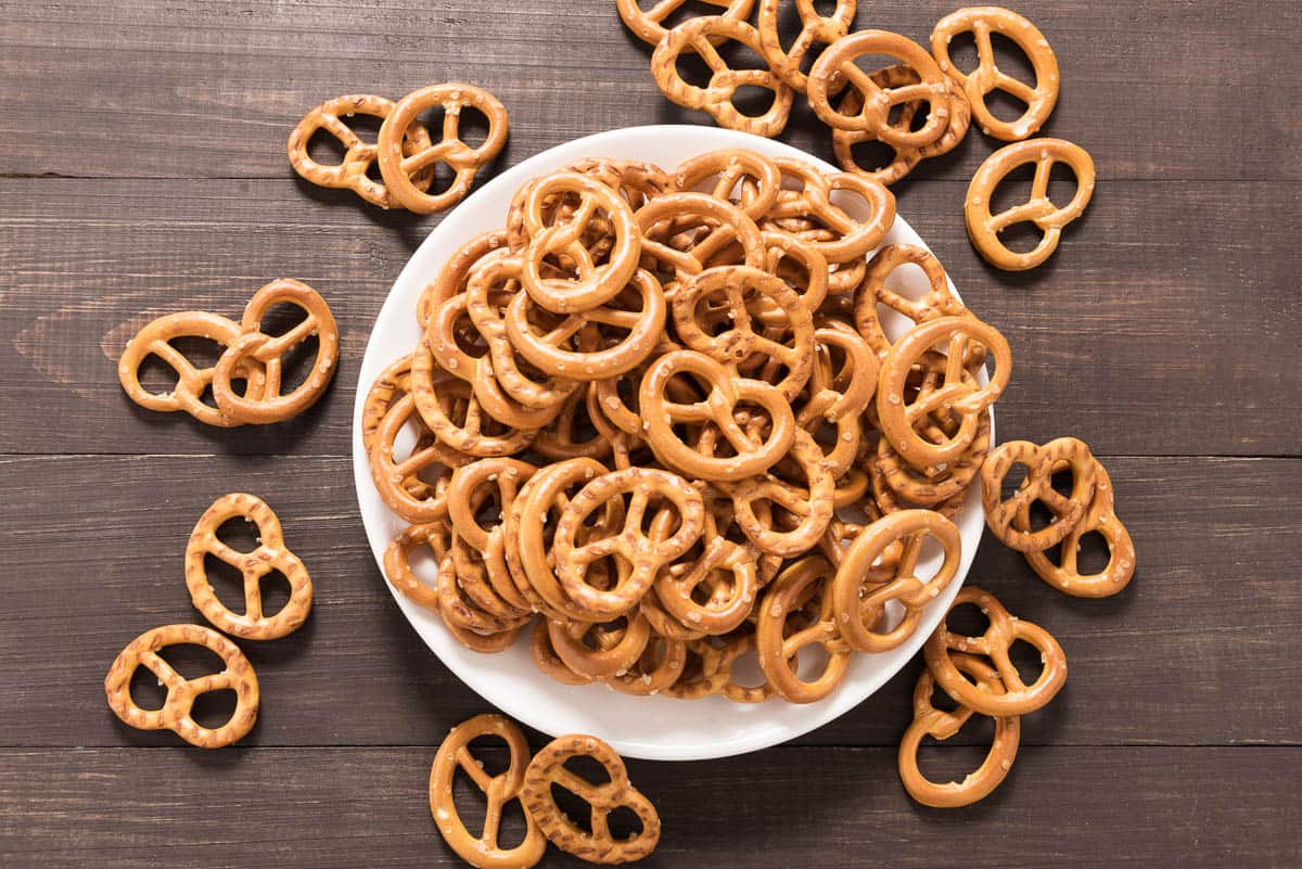 Pretzel in white dish on the wooden background.