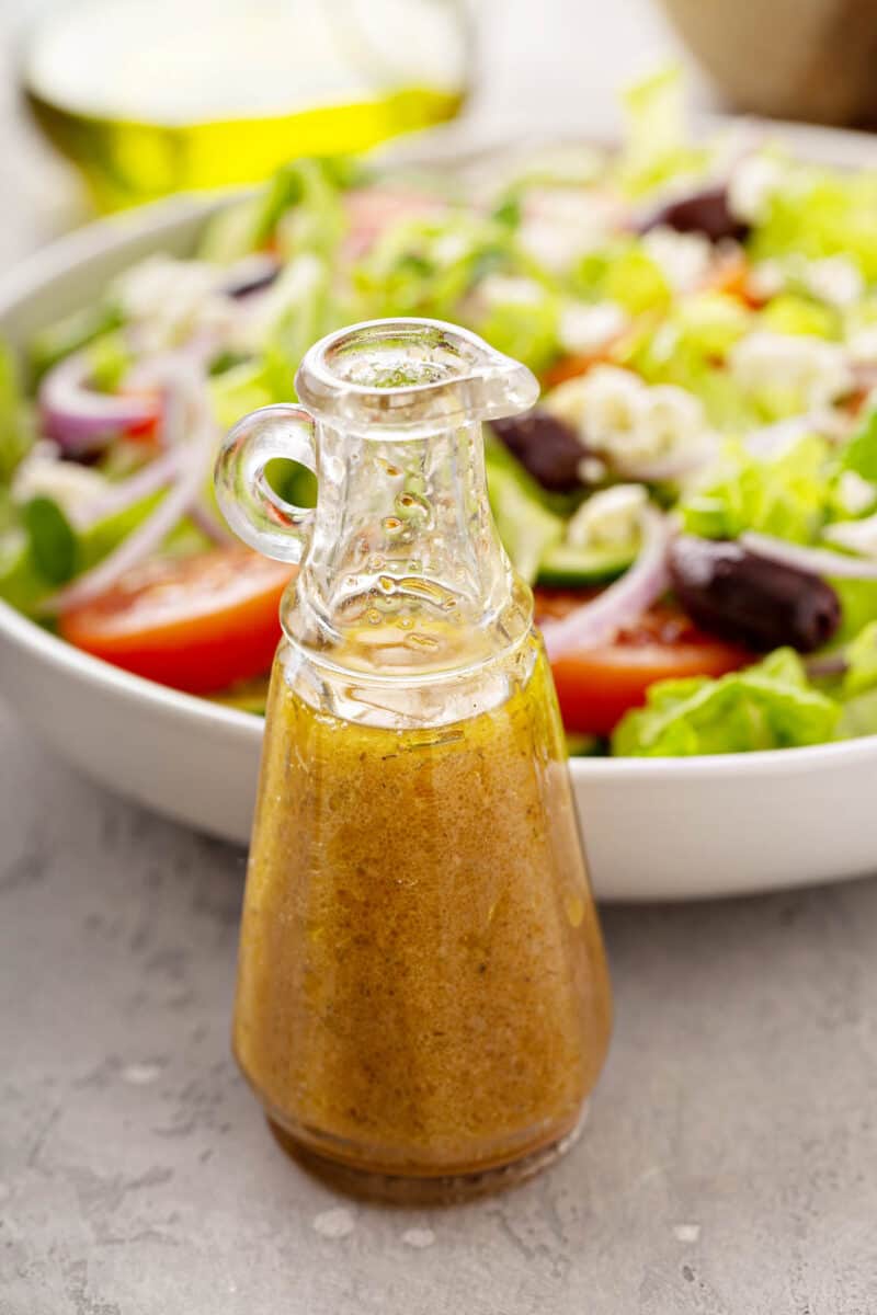 Homemade vinaigrette salad dressing with olive oil, vinegar and herbs.