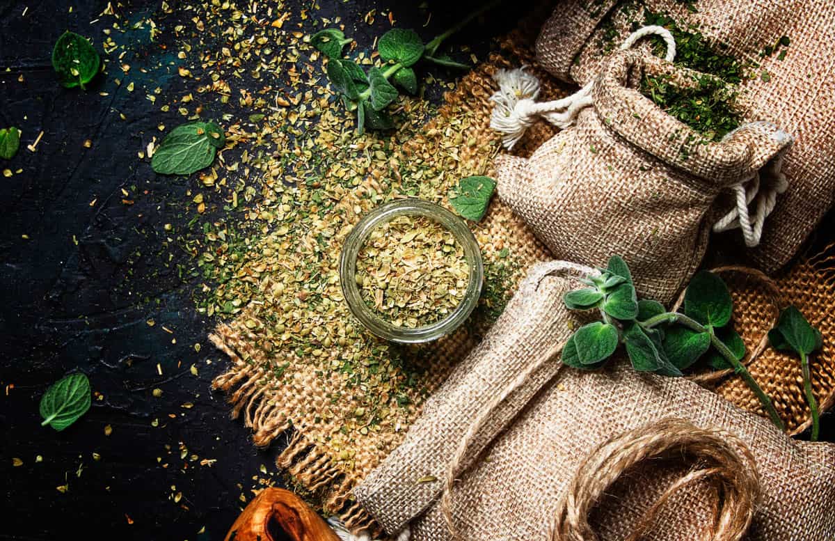 Dried ground oregano or marjoram, dark background, top view.