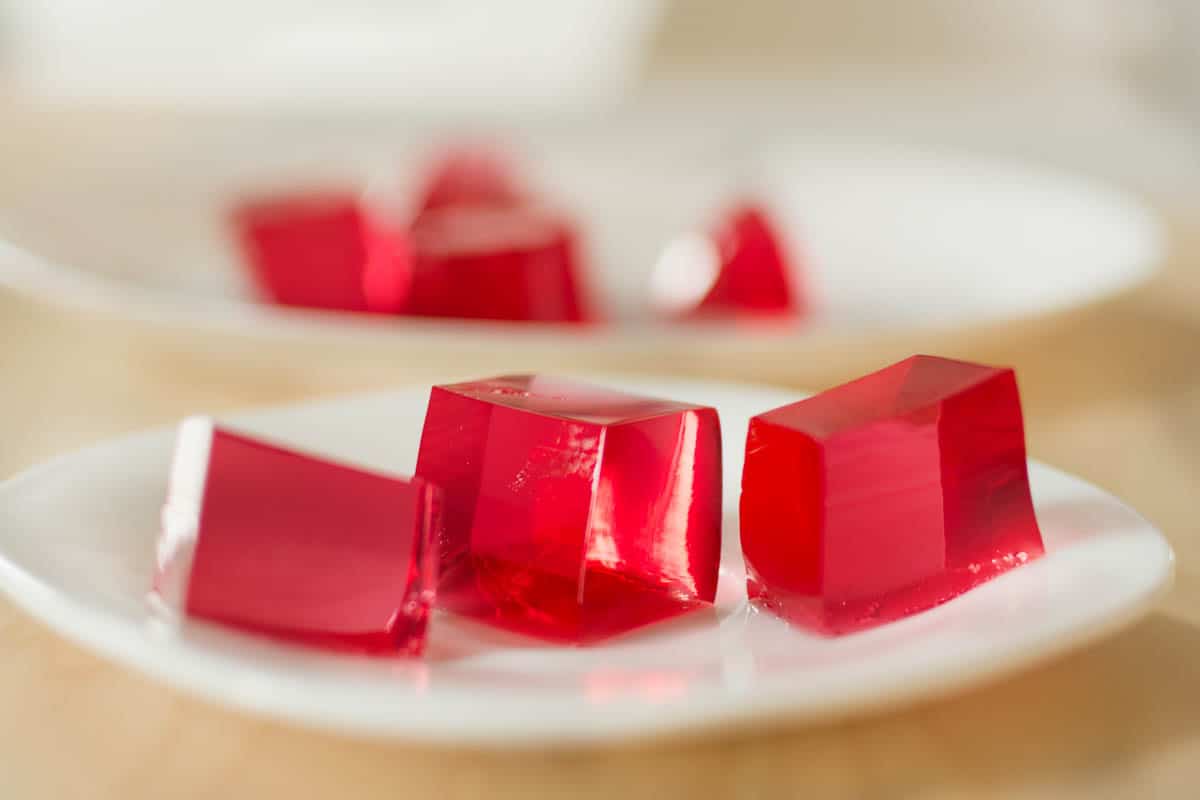 cubes of red jello on plate.