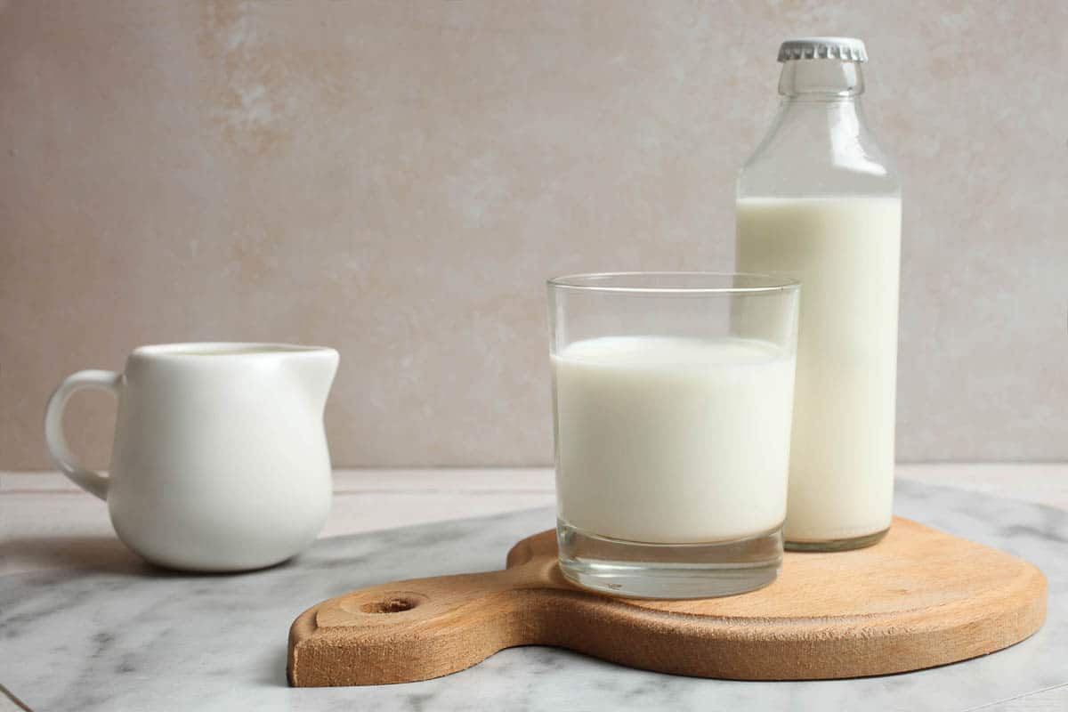 Milk in glass and glass bottle.