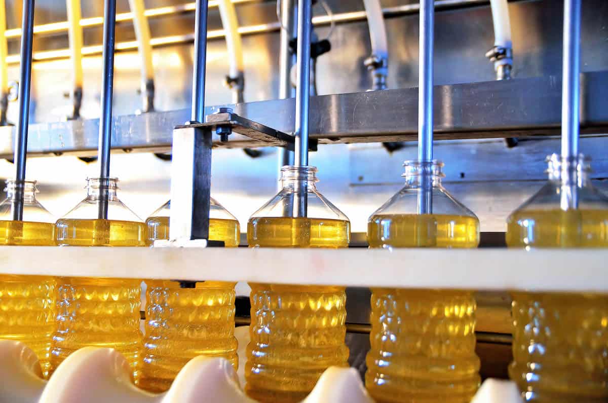 factory line filling plastic bottles with cooking oil.