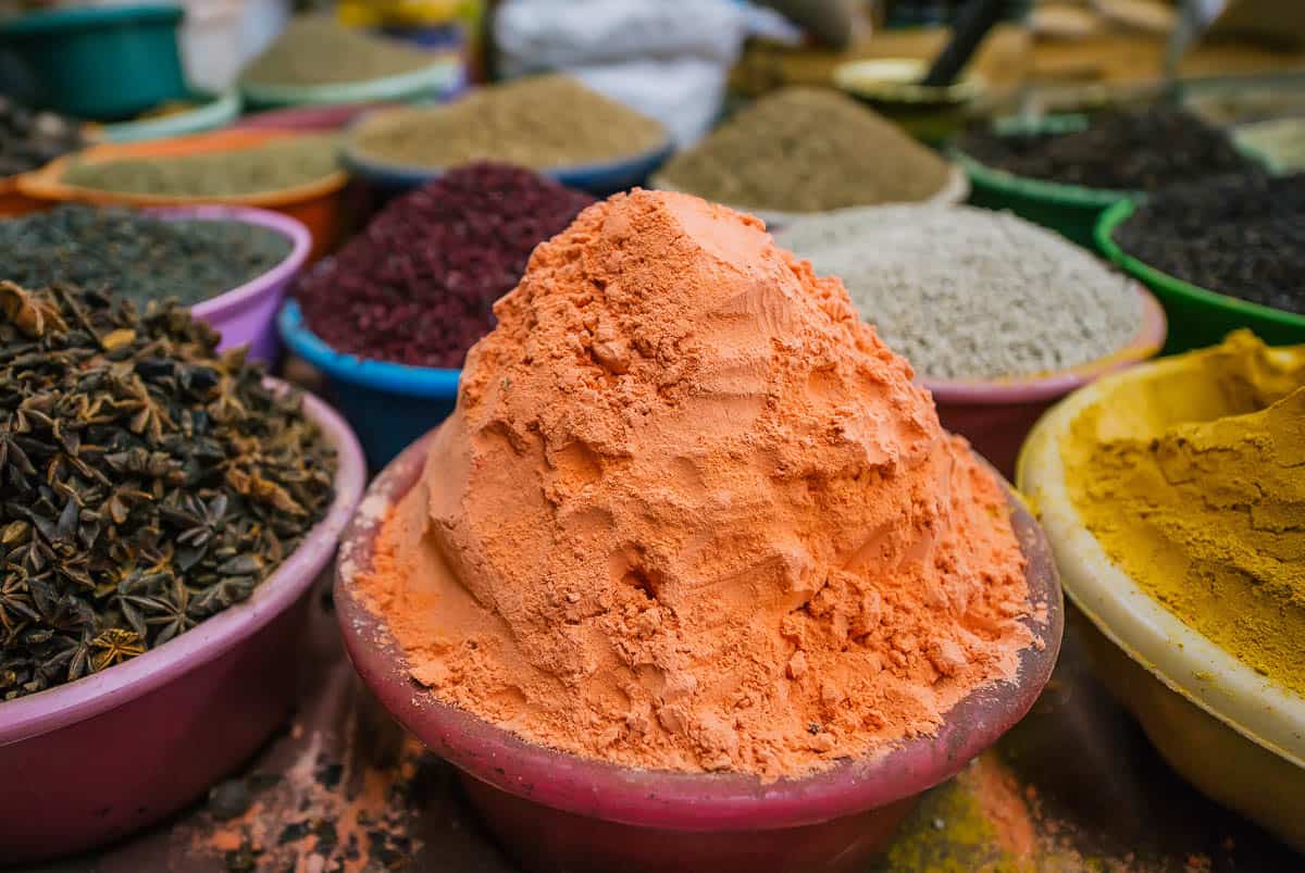 Closeup of different kind of traditional east spices sold in a shop. Selective focus in sambar.