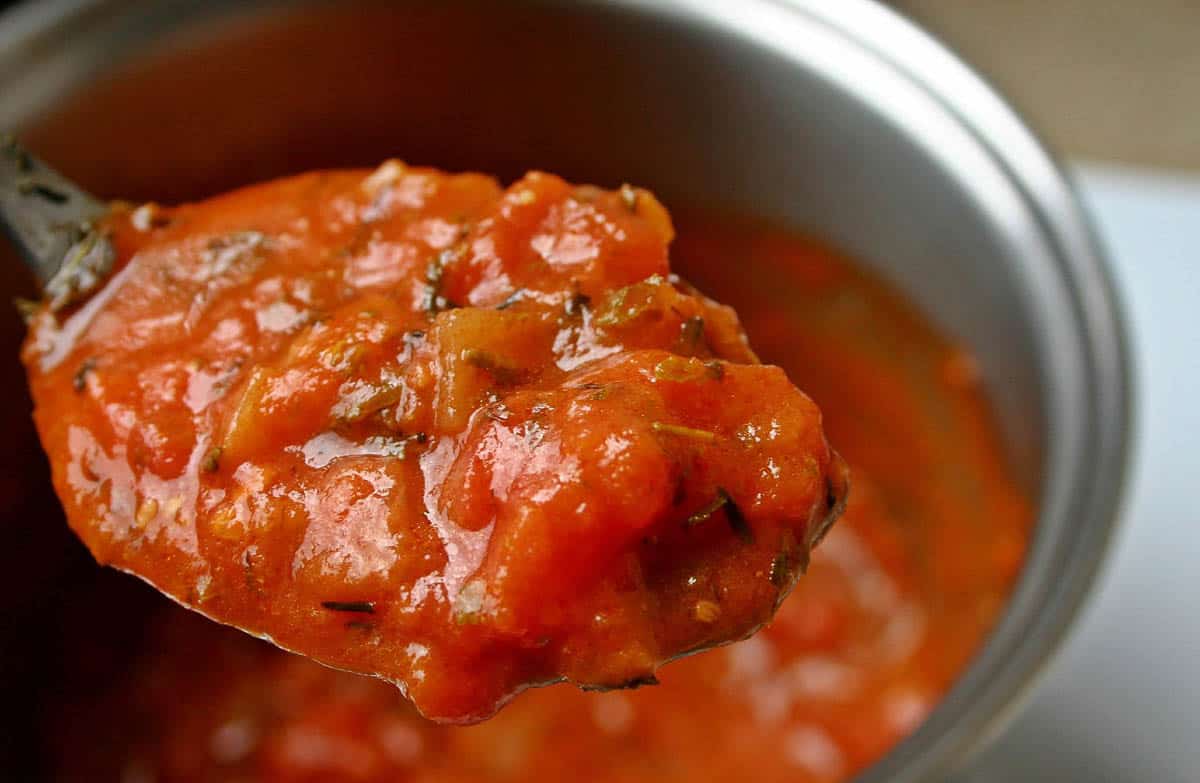 chunky cooked tomatoes on spoon