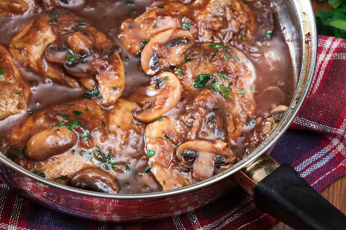 Delicious chicken marsala on frying pan.