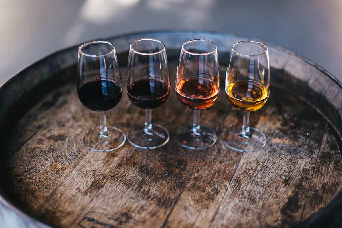 Four different sorts of wine produced in Porto, Portugal. Wine store indoor photos. Wine in glasses.