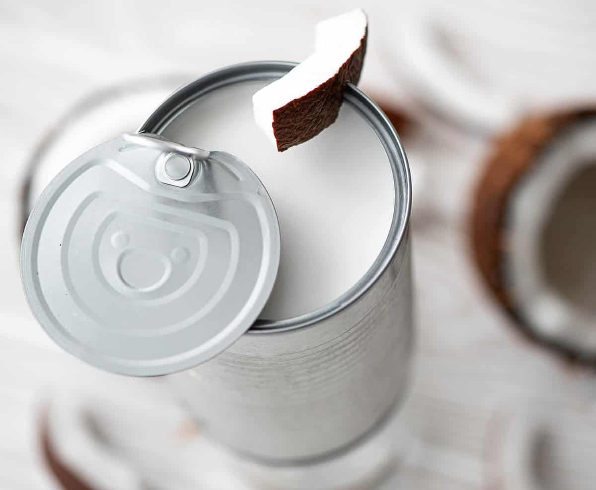 coconut milk in an open can with coconut.