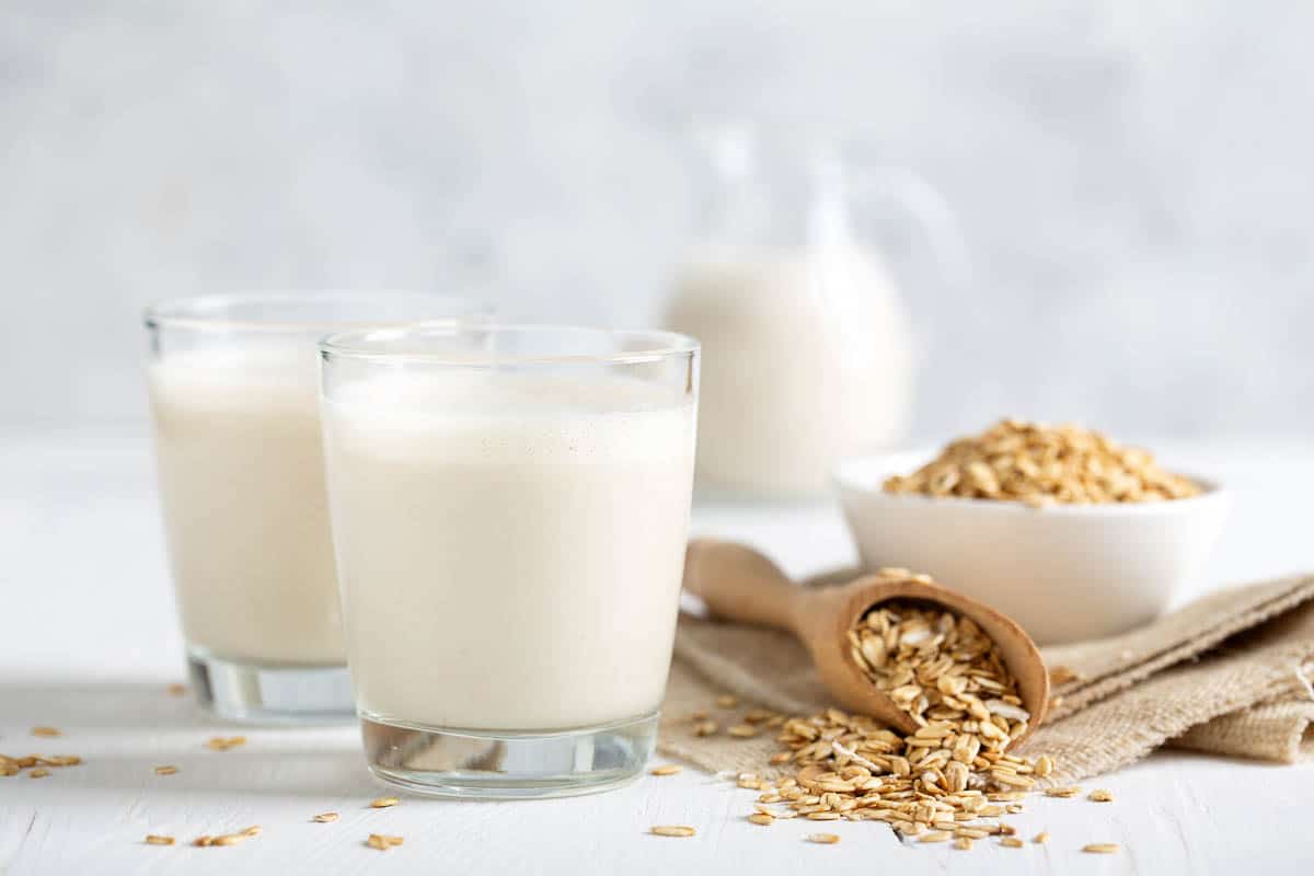 Oat milk. Healthy vegan non-dairy organic drink with flakes.