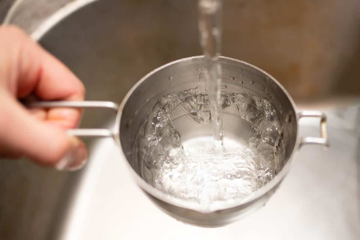 Pour water into measuring cup.