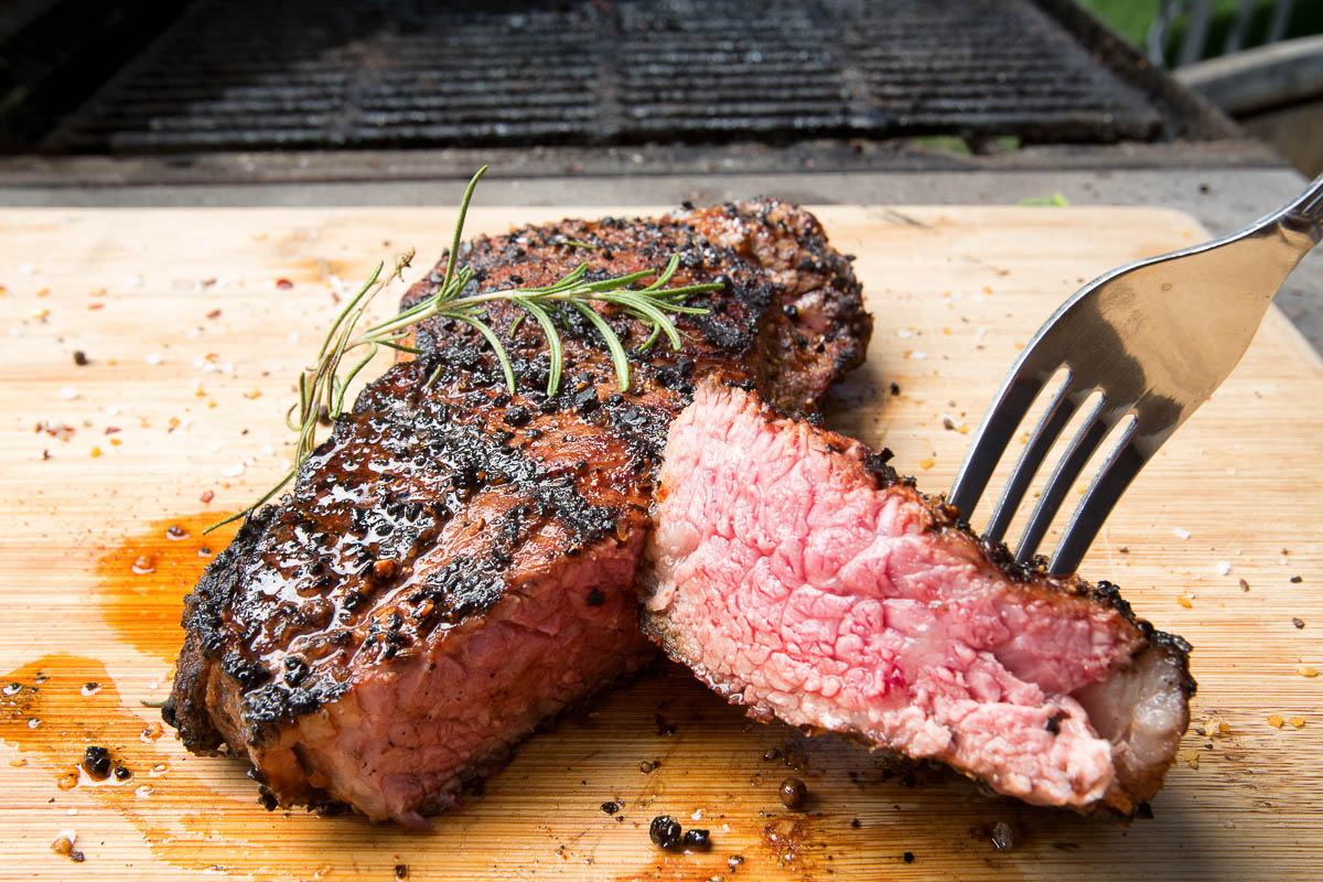 Freshly cooked New York Strip garnished with fresh Rosemary.