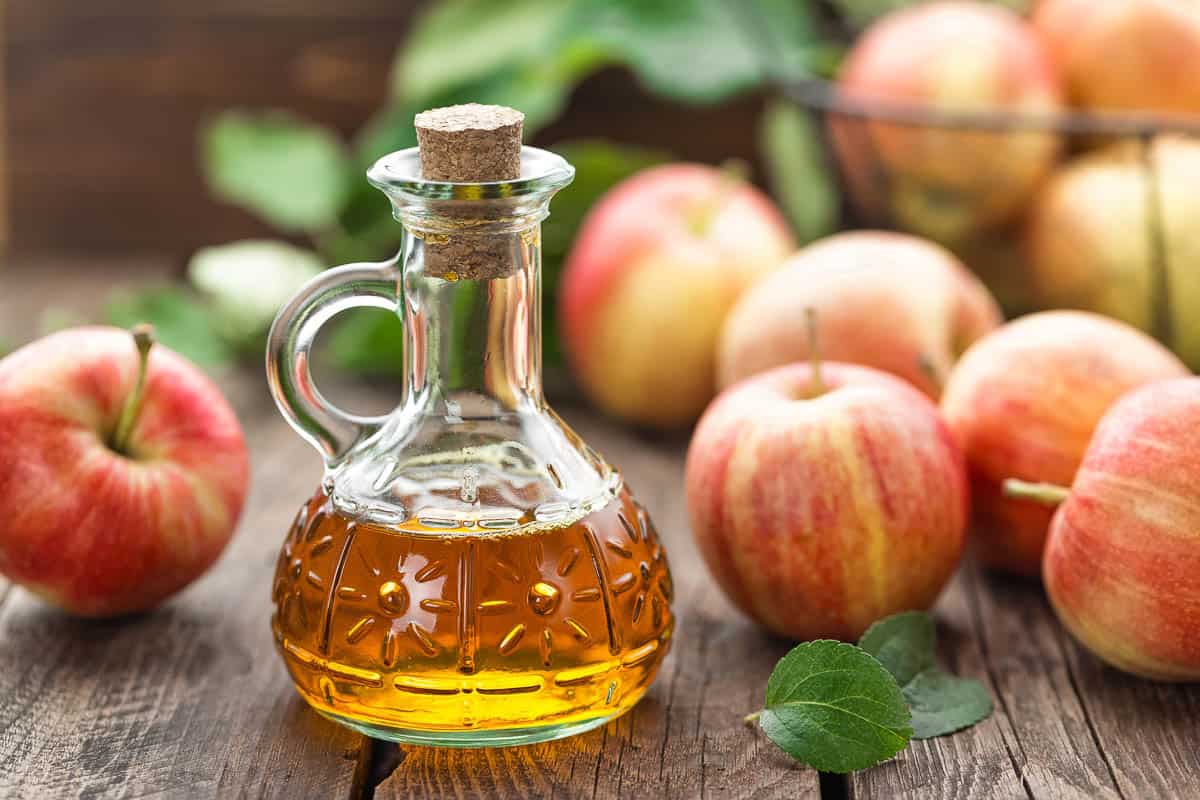 apple cider vinegar in glass jar with apples used for baking.