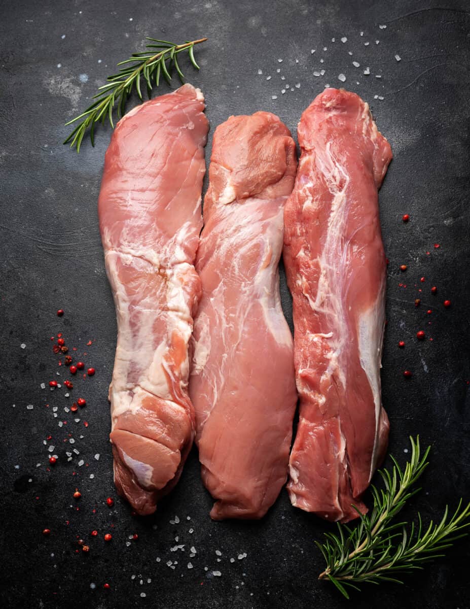 Fresh Raw pork tenderloin on dark background.