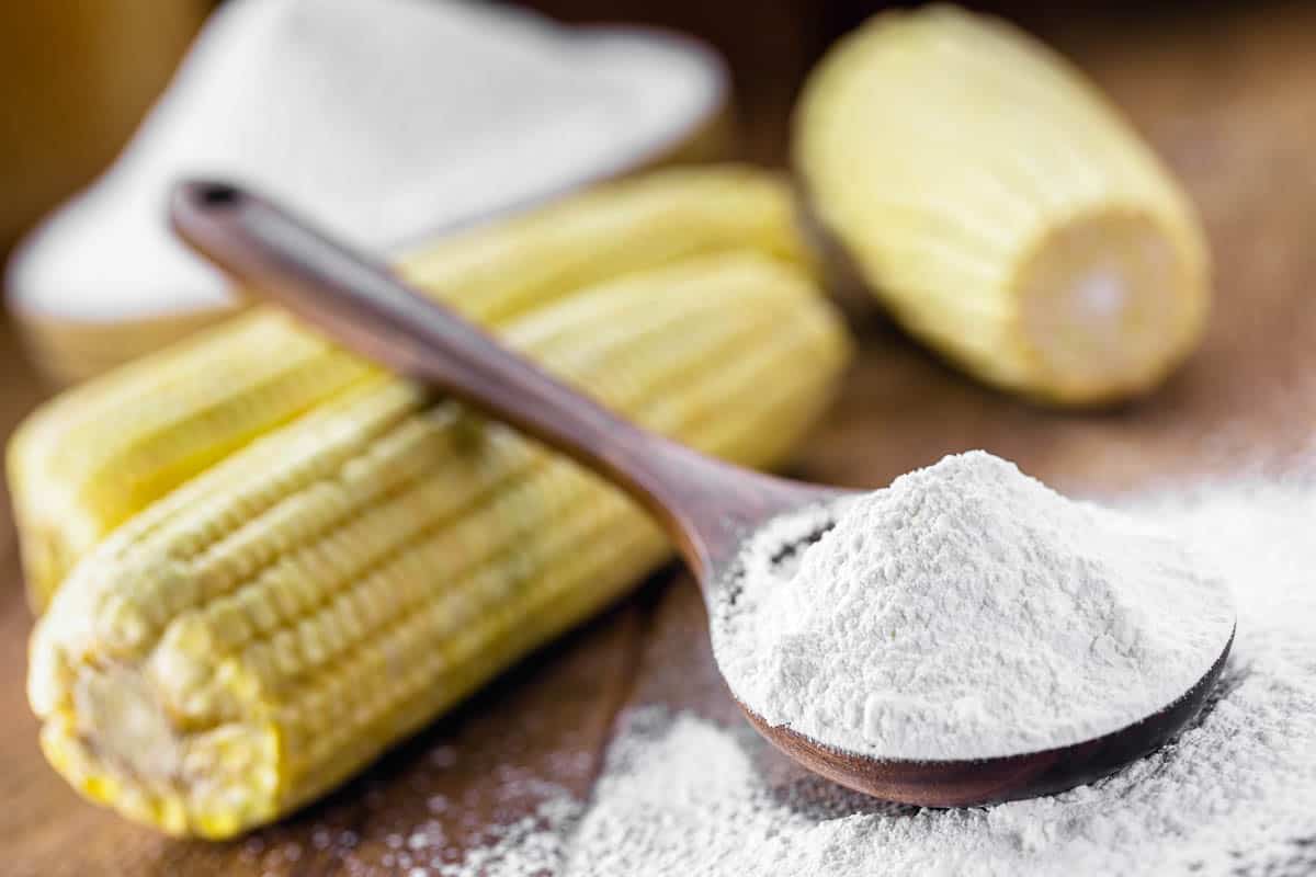 scoop of cornstarch with corn in background