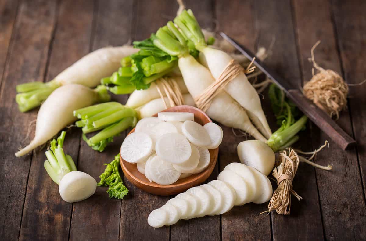 White daikon radishes on the wooden table.