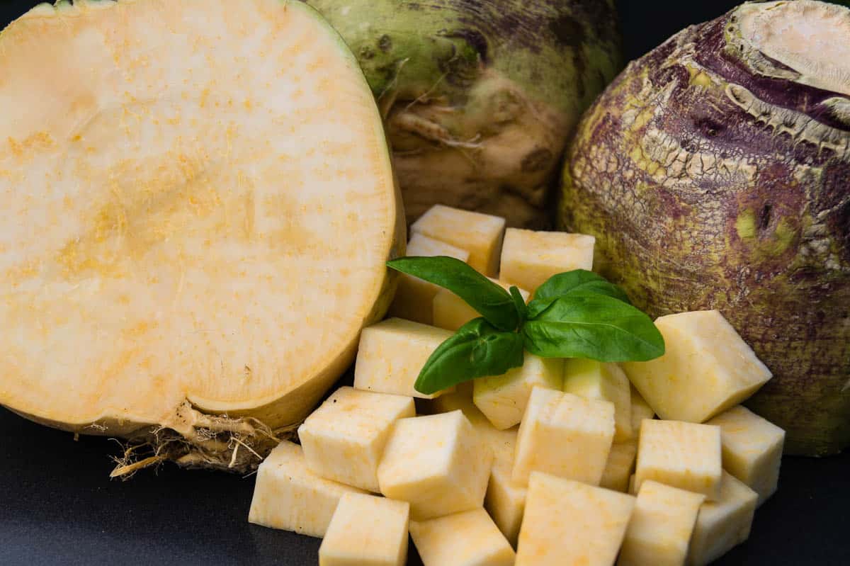 whole, cut in half, and cubed raw rutabaga..
