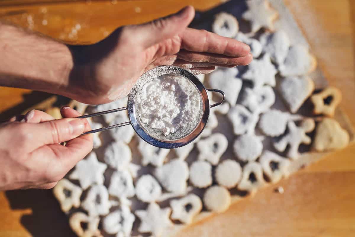 Powdered sugar falling on Linzer cookies.