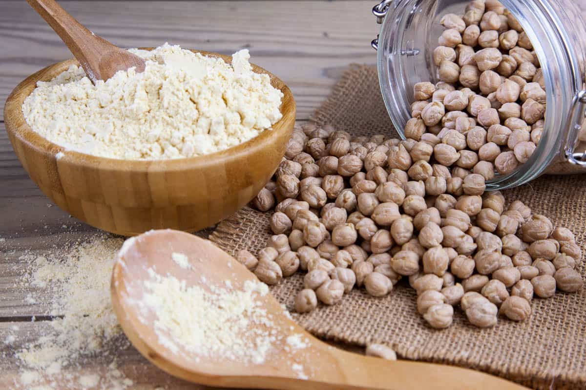 Jar with dried chickpeas and chickpea flour.