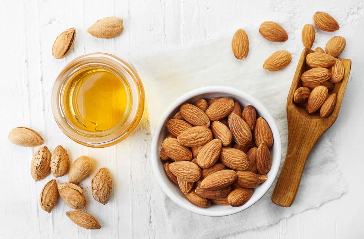 Almond oil and bowl of almonds.