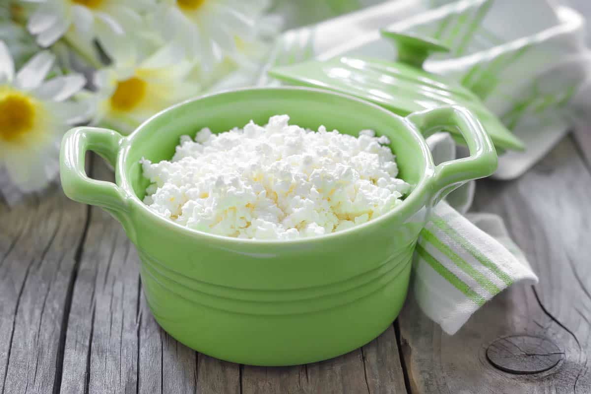 Cottage cheese in a green dish.