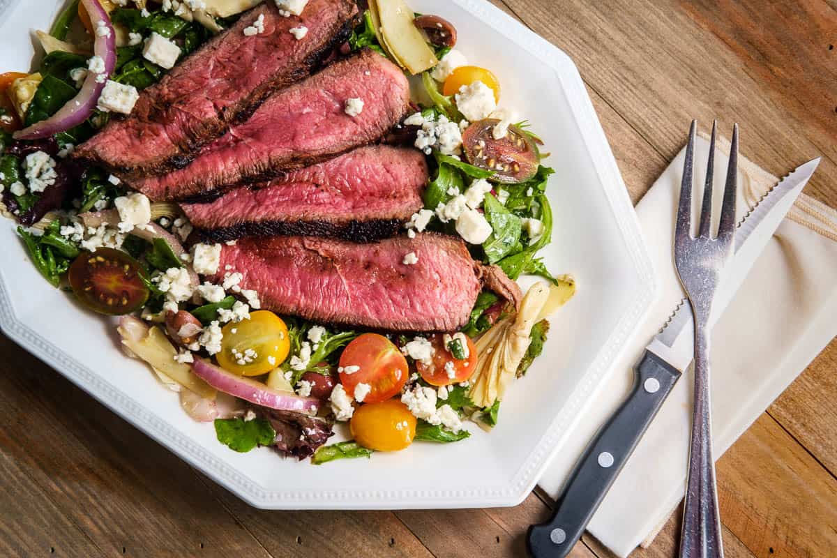 Blue cheese steak salad cooked rare with kalamata olives and artichoke hearts.