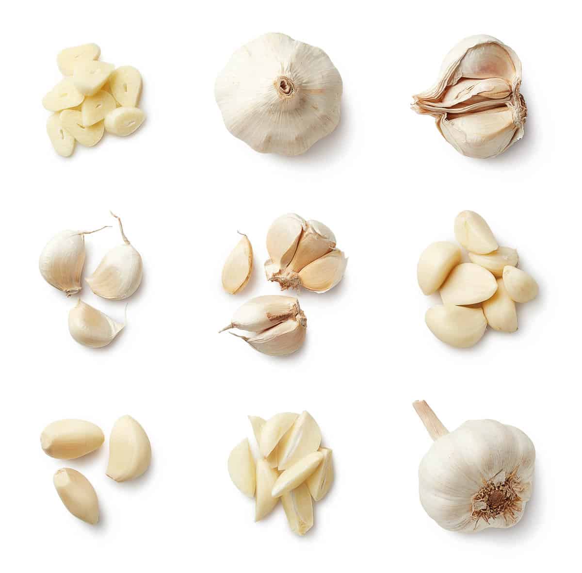 Set of fresh whole and sliced garlics isolated on white background.