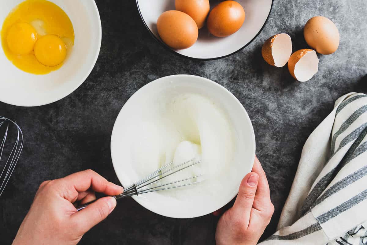 Whipping white eggs with whisk.