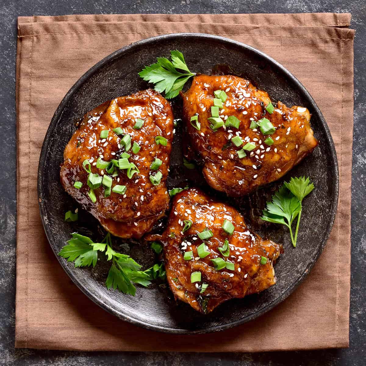 sweet and spicy honey grilled chicken thighs on plate.