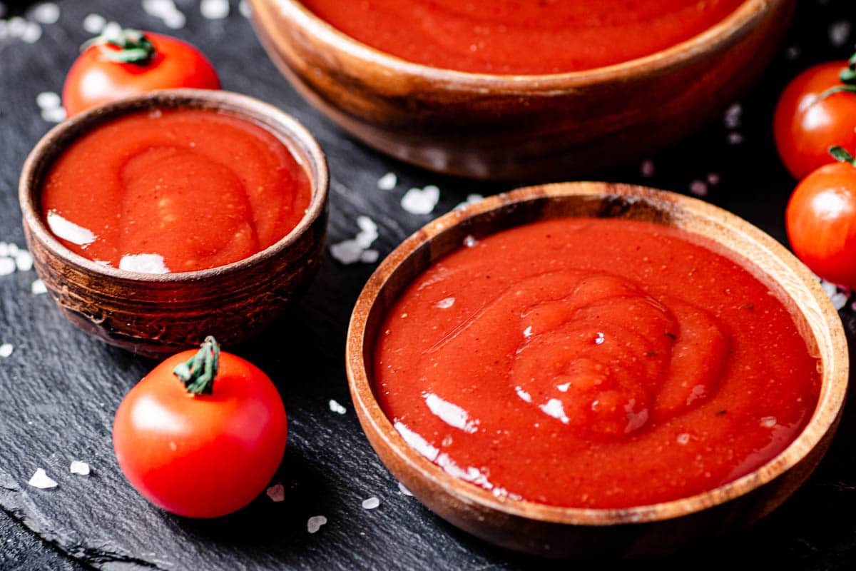 tomato ketchup in small wooden bowls.